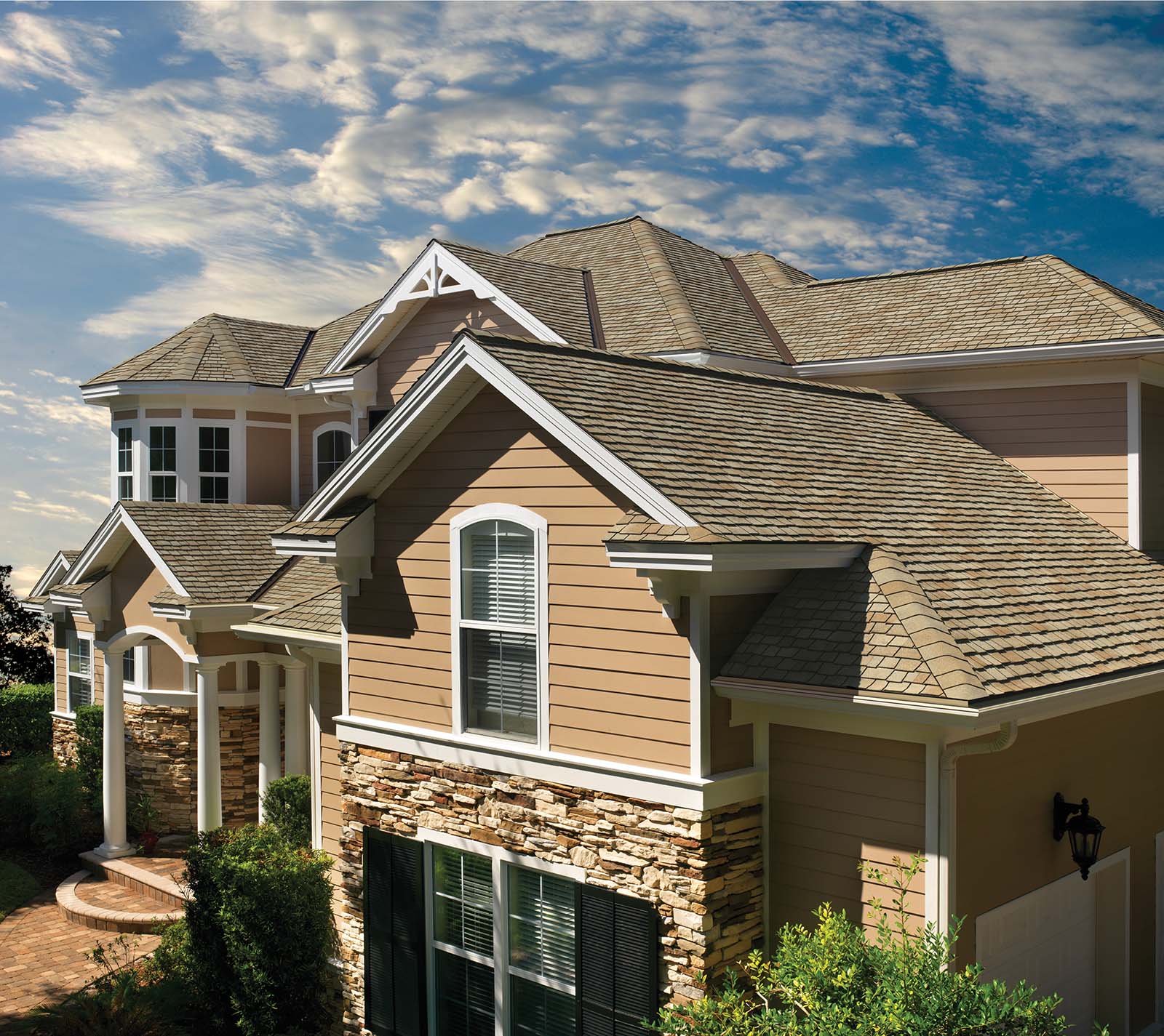 tan siding with brownish beige asphalt roofing